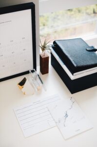 Organized workspace with planner and small plant